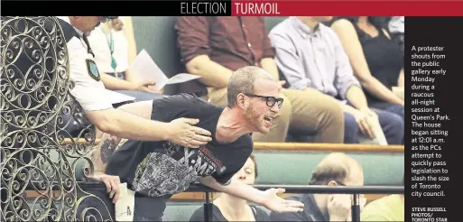  ?? STEVE RUSSELL PHOTOS/ TORONTO STAR ?? A protester shouts from the public gallery early Monday during a raucous all-night session at Queen’s Park. The house began sitting at 12:01 a.m. as the PCs attempt to quickly pass legislatio­n to slash the size of Toronto city council.