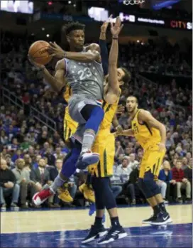  ?? CHRIS SZAGOLA — THE ASSOCIATED PRESS ?? The 76ers’ Jimmy Butler, left, passes while being guarded by Utah’s Ricky Rubio, right, during the first half on Friday in Philadelph­ia.