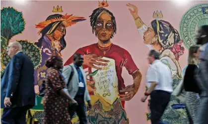  ?? Photograph: Mohammed Abed/AFP/Getty ?? Cop27 participan­ts walk past a climate mural in the conference’s Youth and Children Pavilion in Sharm el-Sheikh, Egypt.