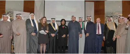  ?? — Photos by Yasser Al-Zayyat ?? KUWAIT: Officials and members of martyrs’ families pose for a group photo during the event.