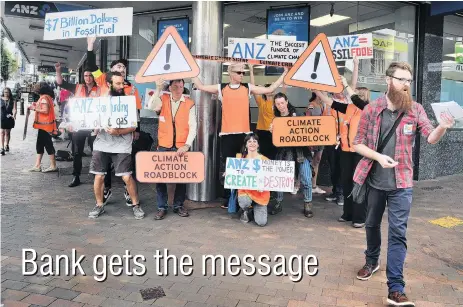  ?? PHOTO: CHRISTINE O’CONNOR ?? Climate of change . . . Supporters of climate activism group 350 Dunedin, who marched to an ANZ branch yesterday to deliver a recent climate change report and protest the bank’s investment in the fossil fuel industry.