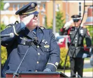  ?? GREG LYNCH / STAFF ?? Police Sgt. Larry Cornett salutes during the Police Memorial Observance in Lebanon in 2012. Cornett graduated from Waynesvill­e High School.