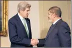  ?? JACQUELYN MARTIN/THE ASSOCIATED PRESS ?? U.S. Secretary of State John Kerry shakes hands with Egyptian President Mohamed Morsi in Cairo, Egypt, on Sunday.