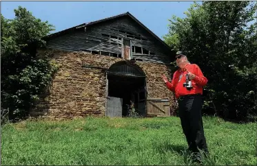  ?? NWA Democrat-Gazette/ANDY SHUPE ?? Glenn Jones, a Benton County historic preservati­on commission­er, speaks Friday at Fitzgerald Station on Old Wire Road in Springdale. The property recently went into foreclosur­e, creating concern for its future among local preservati­onists.