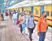  ??  ?? Passengers arriving from outstation trains queue up for a Covid-19 test at Dadar station, in Mumbai on Friday.