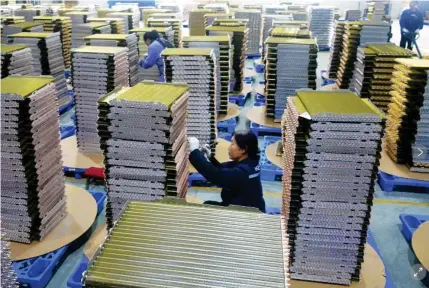  ?? AP PHOTO ?? n Photo shows workers in an airconditi­oning parts factory located in Yuexi county in Central China’s Anhui province on Feb. 21, 2024.