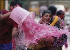  ?? (AP/Mahesh Kumar A.) ?? Children play with colored water Tuesday as they celebrate Holi in Hyderabad, India.