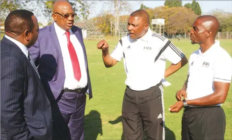  ??  ?? LEADERS ENCLOSURE ... FIFA instructor Felix Tangawarim­a (second from right) and his colleague Mark Mzengo (right) share pointers with ZIFA president Philip Chiyangwa (second from left) and his deputy Omega Sibanda at Prince Edward yesterday