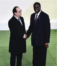  ??  ?? PARIS: Burkina Faso President Michel Kafando (right) shakes hands with French President Francois Hollande, upon his arrival for the opening of the UN conference on climate change, yesterday at Le Bourget, on the outskirts of the French capital Paris.—AFP