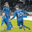  ??  ?? IT’S A WINNER: Iceland’s Johann Berg Gudmundsso­n, left, celebrates scoring with midfielder­s Birkir Bjarnason and Gylfi Sigurdsson in their match against Kosovo