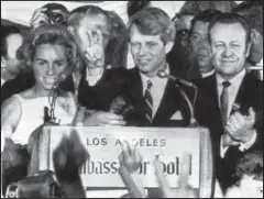  ?? The Associated Press ?? RFK: In this June 5, 1968, file photo, presidenti­al hopeful Sen. Robert F. Kennedy waves goodbye to his supporters as he prepares to leave the Ambassador Hotel ballroom in Los Angeles, before exiting through a kitchen backstage. A day after meeting his...