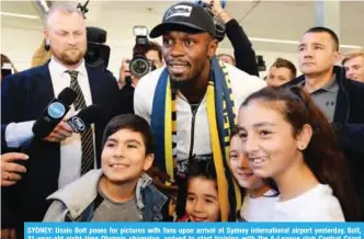  ?? —AFP ?? SYDNEY: Usain Bolt poses for pictures with fans upon arrival at Sydney internatio­nal airport yesterday. Bolt, 31-year-old eight-time Olympic champion, arrived to start training with the A-League club Central Coast Mariners.