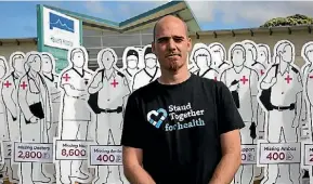  ?? JANE MATTHEWS/FAIRFAX NZ ?? Simon Oosterman stands with 200 cut outs at Hawera Hospital that represent the 20,000 health workers New Zealand is short of.