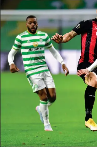  ??  ?? Ryan Christie fends off the challenge of AC Milan striker Zlatan Ibrahimovi­c in the 3- 1 defeat to the Serie A leaders