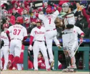  ?? CHRIS SZAGOLA — THE ASSOCIATED PRESS ?? The Phillies’ Maikel Franco, center, celebrates his two-run home run with teammates as Miami Marlins catcher Bryan Holaday, right, looks on during the seventh inning of a baseball game, Thursday in Philadelph­ia.