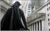  ?? RICHARD DREW — THE ASSOCIATED PRESS FILE ?? The statue of George Washington on the steps of Federal Hall faces the facade of the New York Stock Exchange. U.S. stocks bounced around Wednesday and finished little changed after Congress passed the Republican-sponsored tax bill. Smaller companies...