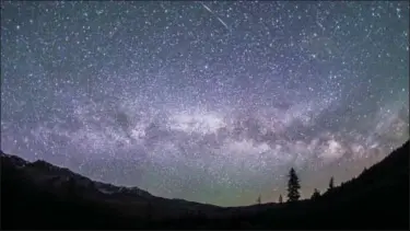  ?? NILS RIBI PHOTOGRAPH­Y VIA AP ?? This photo provided by Nils Ribi Photograph­y shows the Milky Way in the night sky at the foot of the Boulder Mountains in the Sawtooth National Recreation Area, Idaho. Tourists heading to central Idaho will be in the dark if local officials get their...