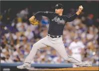  ?? The Associated Press ?? MUST-WIN: Atlanta pitcher Sean Newcomb throws to a Dodgers batter Thursday during the third inning of Game 1 of the National League Division Series in Los Angeles.