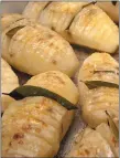  ?? FILE PHOTO ?? Fanned Potatoes, cut not-quitethrou­gh and with a bay leaf inserted, fan out as they bake.
Coarse salt (kosher or sea), to taste