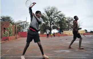  ??  ?? The players have only one ball, which long ago lost its bounce. The lack of tennis balls means the boys generally play doubles games.