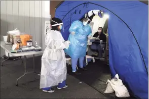  ?? Ned Gerard / Hearst Connecticu­t Media ?? Medical personnel conduct the daily drive-thru COVID-19 testing at Bridgeport Hospital on Dec. 9.