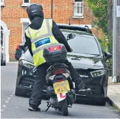  ?? ?? A parking warden with an L-plate delivers a ticket to a driver parked in a suspended bay in Clapham, South London