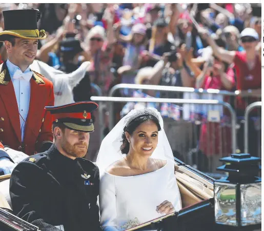  ?? Photo: Jeff J Mitchell/AP ?? Meghan Markle looks radiant as she rides in a carriage with her new husband Prince Harry.