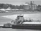  ?? JIM WEBER/THE COMMERCIAL APPEAL ?? Barge traffic passes down the Mississipp­i River near the West Memphis Port on June 27, 2012.