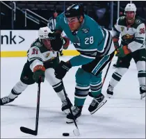  ?? JOSE CARLOS FAJARDO — STAFF PHOTOGRAPH­ER ?? The Sharks’ Timo Meier moves the puck against Minnesota’s Carson Soucy in the Wild’s 5-3 victory Saturday night.