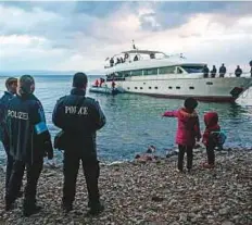  ?? AP/Rex Features ?? Top: Divers search a yacht used to transport refugees illegally that overturned in a fatal accident at the port of Vathy on the Greek island of Samos in May 2014.