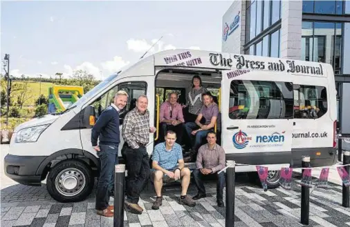  ??  ?? DRIVING SEAT: Staff from Nexen Petroleum, who have donated the 17-seat minibus prize, are on board with the charitable initiative