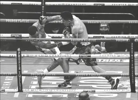  ?? ASSOCIATED PRESS ?? GERVONTA DAVIS (left) is knocked down by Leo Santa Cruz during the first round of a bout on Saturday in San Antonio.