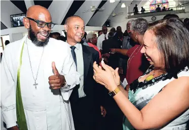  ?? RUDOLPH BROWN/PHOTOGRAPH­ER ?? The Reverend Astor Carlyle (left) gives a thumbs up to Camille Facey, director of the National Solid Waste Management Authority (NSWMA), while Dennis Chung, chairman of the NSWMA, looks on during the National Environmen­t and Planning Agency church...