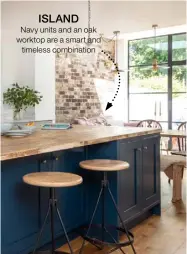  ??  ?? ISLAND
Navy units and an oak worktop are a smart and timeless combinatio­n