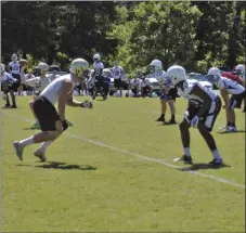  ?? ALEX FARRER / staff ?? Calhoun's Landon Rice (left) runs a route in front of a Mt. Paran Christian defender during Calhoun passing camp last week. The Jackets begin fall practice on Monday.