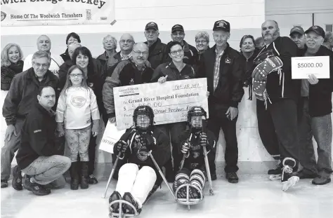  ?? [FAISAL ALI / THE OBSERVER] ?? The Woolwich Sledge Hockey organizati­on and the Grand River Regional Cancer Centre each received $5,000 this year from the Waterloo County Steam-Threshers’ Reunion at the hockey team’s home-opener Saturday at the WMC.