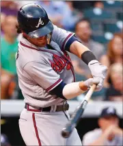  ?? Jack Dempsey / The Associated Press ?? Atlanta’s Dansby Swanson connects for a two-run double off Colorado Rockies starting pitcher Kyle Freeland during the second inning of Tuesday’s game in Denver. DENVER