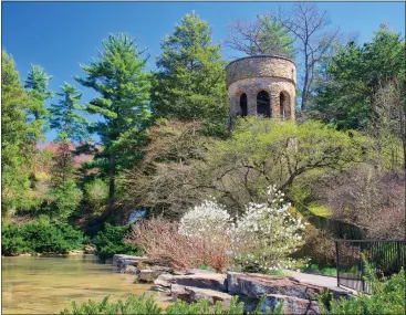  ?? PHOTO BY SCOTT R. HUMMEL ?? The Chimes Tower peeks out of the blossoming treees at Longwood Gardens.