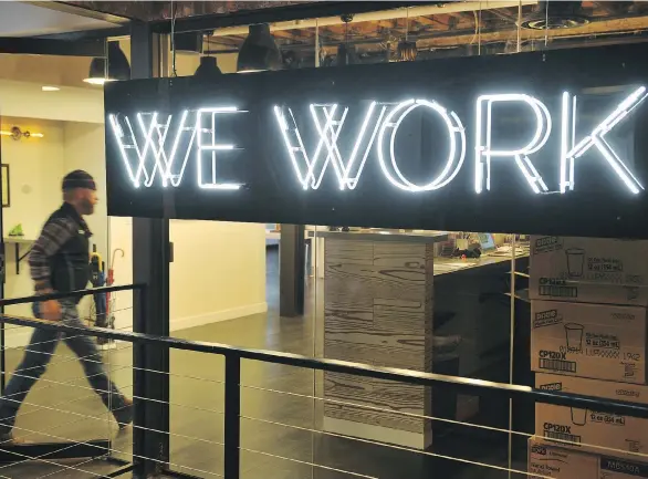  ?? MANDEL NGAN/AFP/GETTY IMAGES FILES ?? A man enters the WeWork coworking space in Washington, D.C. Seattle-based Amazon Inc. swiftly scooped up most of New York-based WeWork Inc. shared office spaces in Vancouver. It will be renting WeWork’s first Vancouver office site, as it does not want...