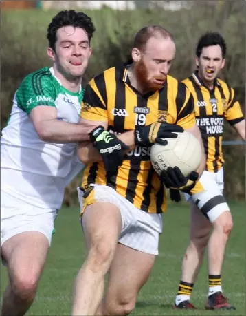  ??  ?? Aidan Cash (Shelmalier­s) is tackled by Shane Murphy of St. James’ during Saturday’s clash.