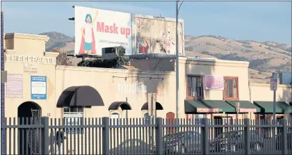  ?? RANDY VAZQUEZ — STAFF ARCHIVES ?? A billboard prompting the use of face mask sits atop a store on North White Road in San Jose in December 2020.