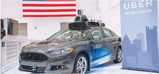  ?? AFP-Yonhap ?? A pilot model Uber self-driving car is displayed at the Uber Advanced Technologi­es Center in Pittsburgh, Pa., Sept. 13, 2016.