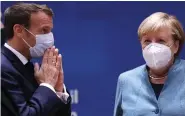  ??  ?? Hoping... Macron and Merkel yesterday