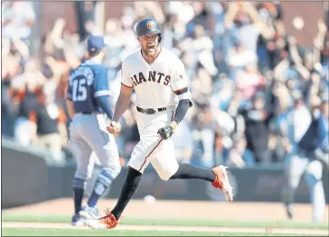  ?? PHOTOS BY NHAT V. MEYER — STAFF PHOTOGRAPH­ER ?? The Giants’ Hunter Pence exults after his dribbler gets past the Padres’ Eric Hosmer for a game-winning double Sunday.