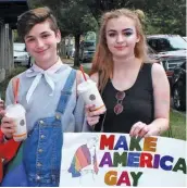  ??  ?? Members of the Starbucks Pride Alliance Network march with giant rainbow flag in 28th annual Central Alabama Pride parade; King and Queen Apollo XL of the Mystic Krewe of Apollo Birmingham; happy teens showing their glittery “Make America Gay Again”...