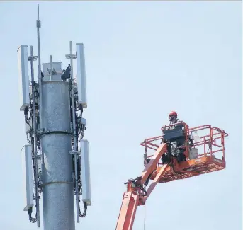  ?? POSTMEDIA NEWS ?? A man works on communicat­ions equipment in Winnipeg. Television service providers saw their business sink for a third straight year, the CRTC said, though the dip for commercial radio stations was smaller.