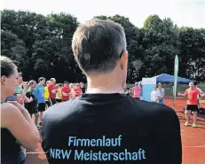  ?? RP-FOTOS (2):KLAUS-DIETER STADE ?? Jan Fitschen (orangefarb­enes Shirt und grüne Schuhe) gab den rund 60 Läufern letzte Tipps vor dem Firmenlauf.