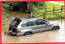  ??  ?? MISERY: Top, dangerous conditions on the M20 in Ashford, Kent, and a cyclist battles away in Cambridge. Above, flooded roads in Hall Green, Birmingham, and Colnbrook, west London. Left, cyclist in Birmingham