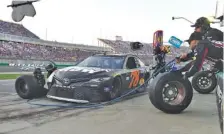  ?? THE ASSOCIATED PRESS ?? Martin Truex Jr. (78) makes a pit stop during Saturday night’s NASCAR Cup auto race at Kentucky Speedway.