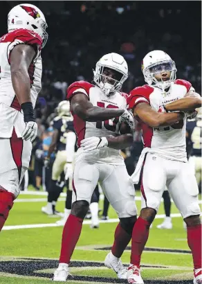  ?? BUTCH DILL/THE ASSOCIATED PRESS ?? Arizona Cardinals’ Christian Kirk, right, celebrates his touchdown reception with Chad Williams, centre, and D.J. Humphries during Friday’s NFL pre-season game in New Orleans.